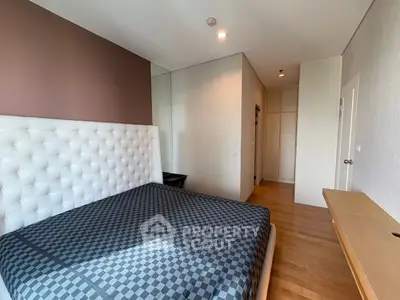Modern bedroom with stylish decor and wooden flooring