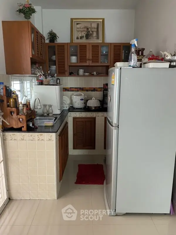 Compact kitchen with modern appliances and wooden cabinets