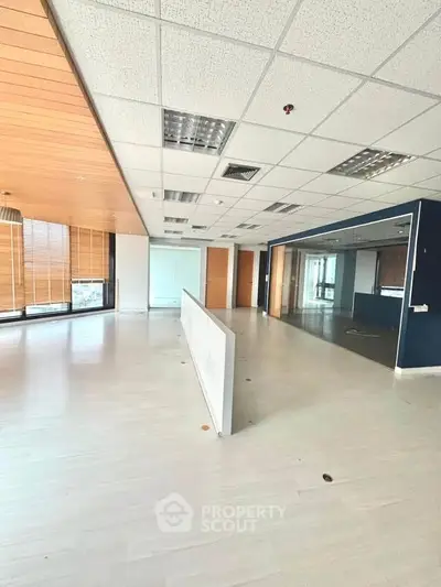 Spacious modern office space with large windows and wooden accents