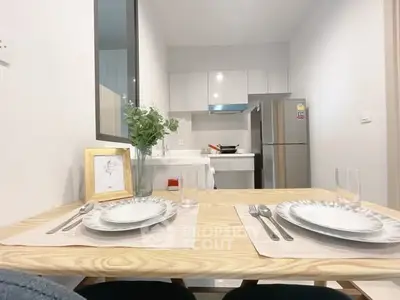 Modern kitchen with dining setup and stainless steel appliances