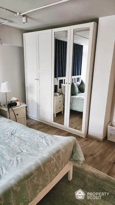 Cozy bedroom with mirrored wardrobe and elegant decor