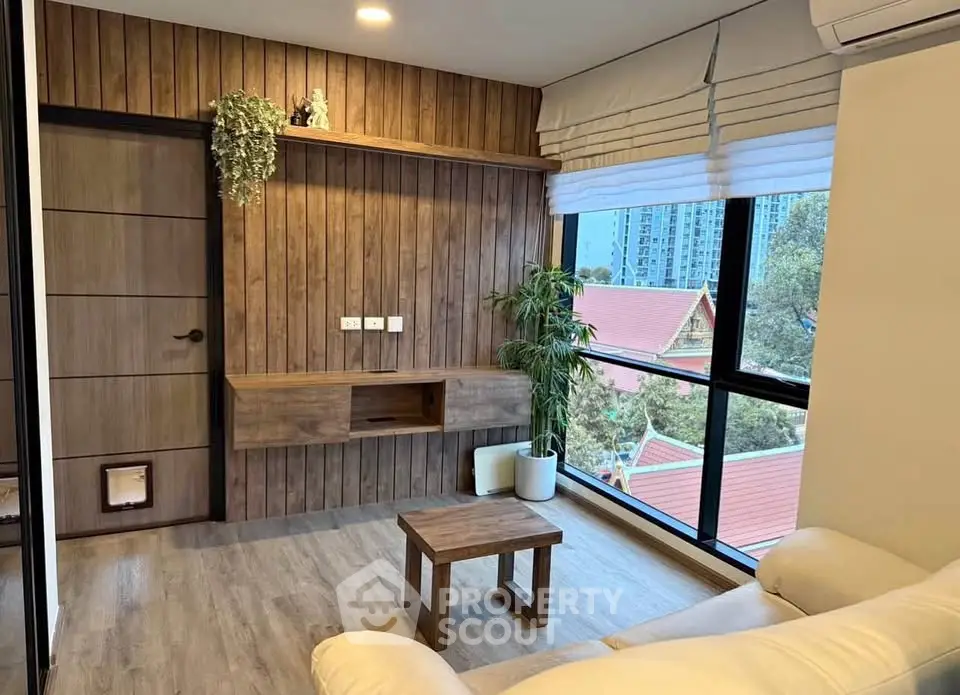 Modern living room with wooden accents and large window offering city view