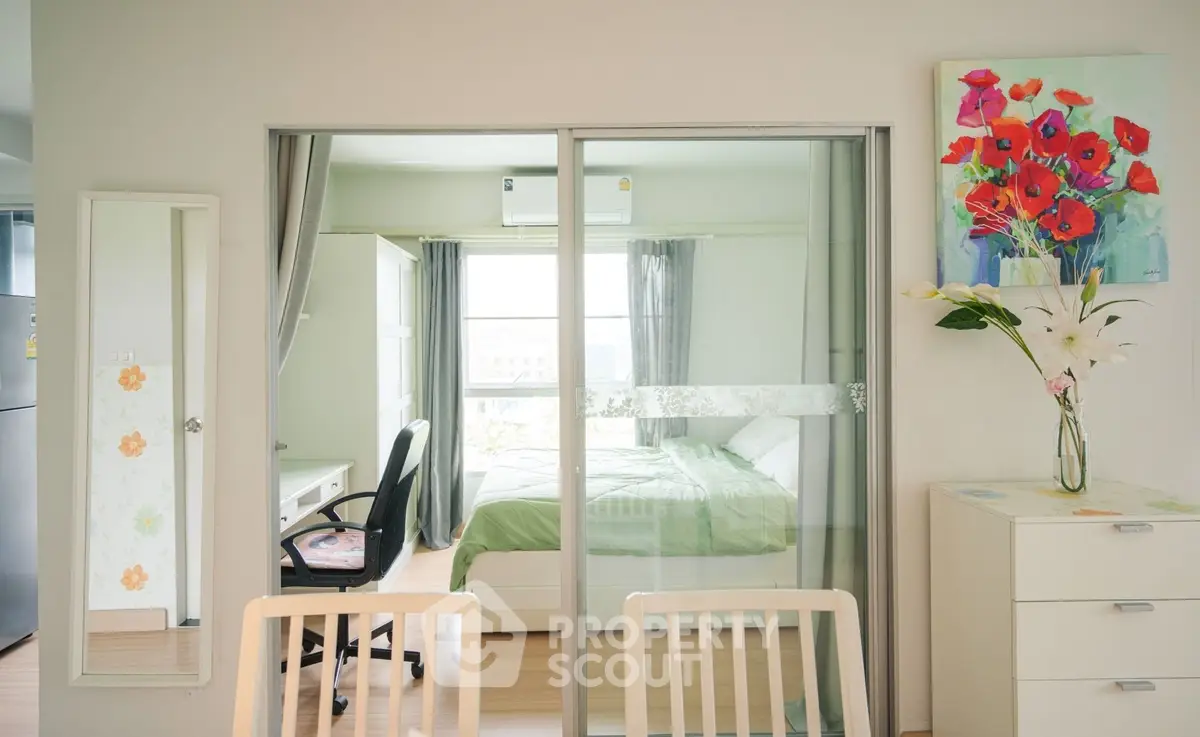 Modern apartment with glass sliding doors, bright bedroom, and stylish decor