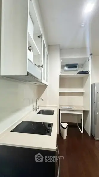 Modern kitchen with sleek white cabinets and electric stove