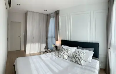 Modern bedroom with stylish decor and ample natural light