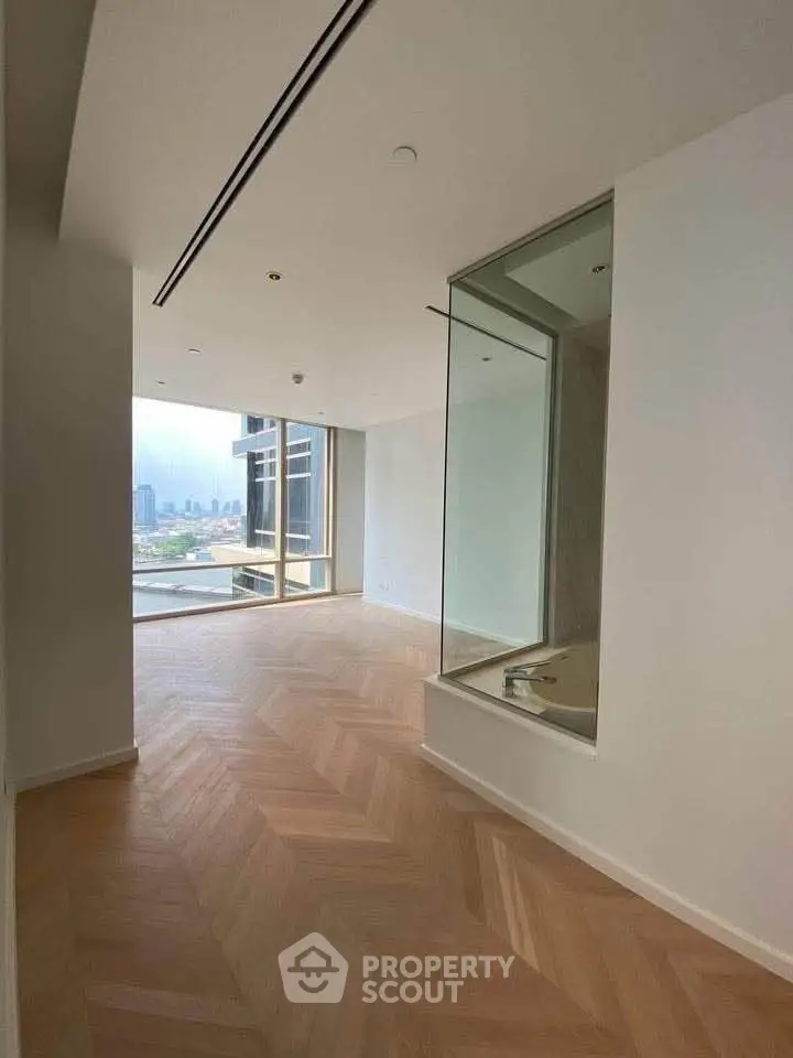 Spacious modern apartment with stunning city view and elegant wooden flooring.