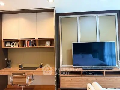 Modern living room with sleek TV setup and stylish workspace