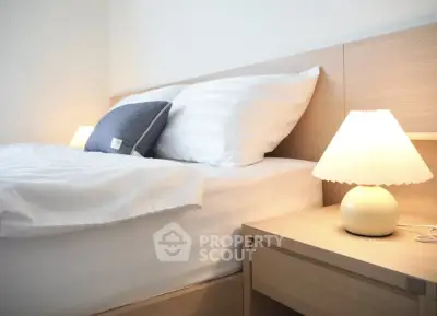 Cozy bedroom with modern wooden furniture and soft lighting, perfect for relaxation.