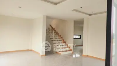 Spacious modern interior with staircase and elegant ceiling design