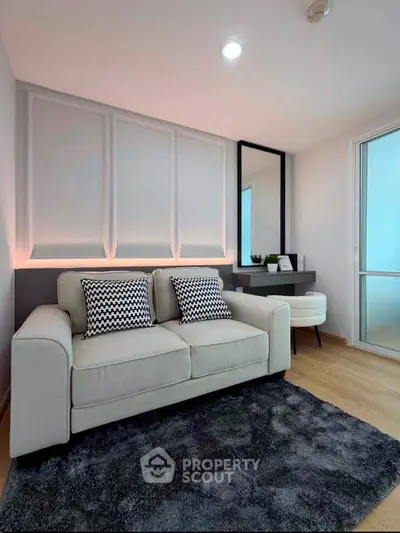 Modern living room with stylish sofa, chic decor, and elegant lighting in a cozy apartment.