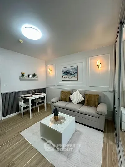 Modern living room with stylish decor, cozy sofa, and elegant lighting in a chic apartment.