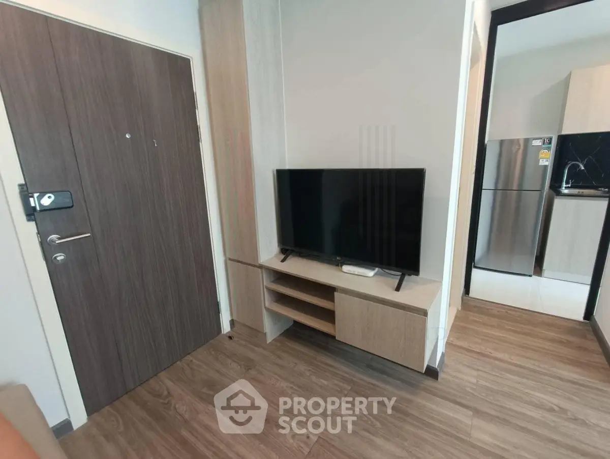 Modern living room with sleek wooden flooring and stylish TV setup
