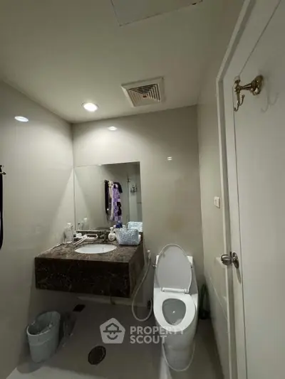 Modern bathroom with sleek design and marble countertop in a contemporary home.