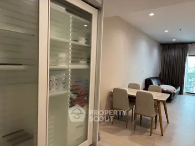 Modern living room with dining area and balcony view in a stylish apartment.