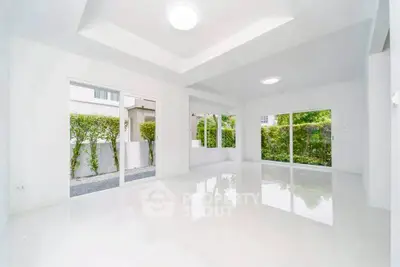 Spacious modern living room with large windows and garden view