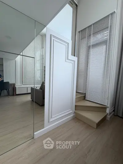 Modern interior with stylish staircase and elegant decor in a contemporary living space.