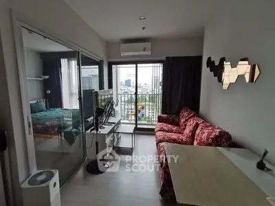 Modern living room with city view, stylish decor, and cozy seating area in a high-rise apartment.