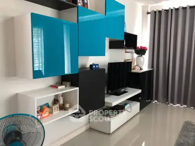 Modern living room with sleek blue and black cabinets and stylish decor