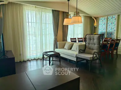 Spacious living room with elegant decor and large windows for natural light.