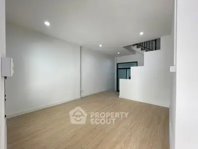 Spacious modern living room with wooden flooring and minimalist design