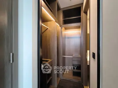 Luxurious walk-in closet with elegant wood finishes and ample storage space.