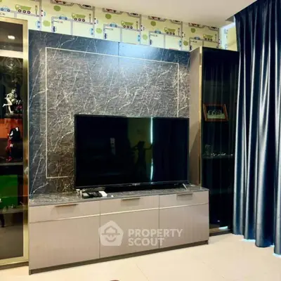 Modern living room with sleek TV unit and elegant marble backdrop