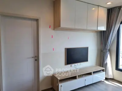 Modern living room with sleek storage and large window view