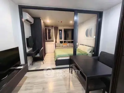Modern studio apartment with sleek design, featuring a cozy bedroom and stylish living area.