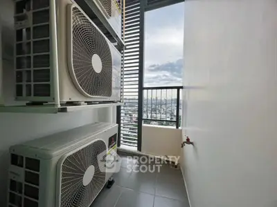 High-rise balcony with air conditioning units and city view.