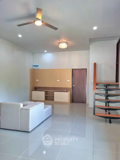 Modern living room with sleek staircase and minimalist design
