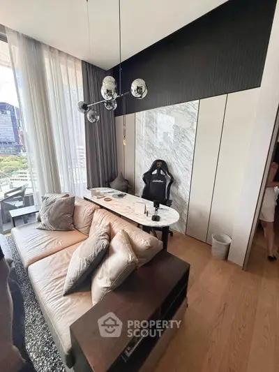 Modern living room with stylish decor and large windows offering city views, featuring a cozy sofa and sleek lighting.
