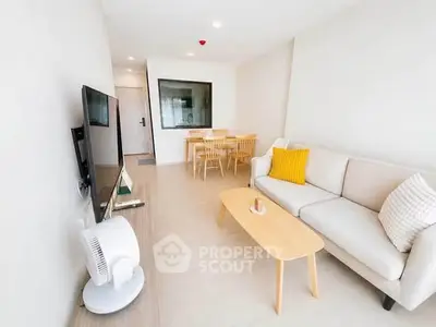 Modern living room with sleek furniture and bright decor in a stylish apartment.