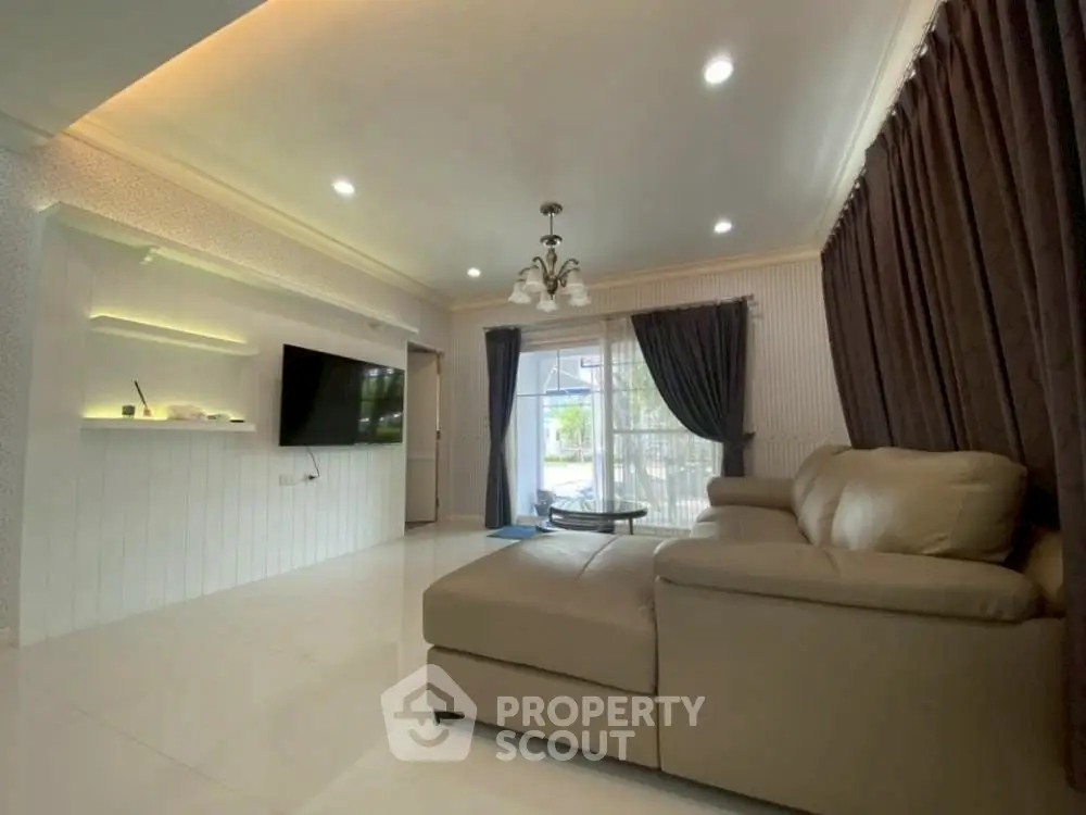 Spacious living room with modern decor and large windows for natural light.