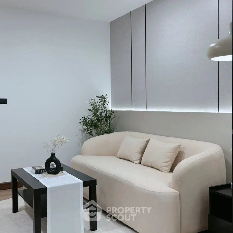 Modern living room with elegant beige sofa and sleek black coffee table