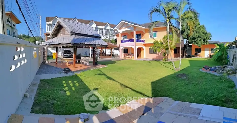 Spacious property with lush garden and charming two-story house, perfect for family living.