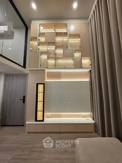 Modern living room with high ceilings and stylish built-in shelving