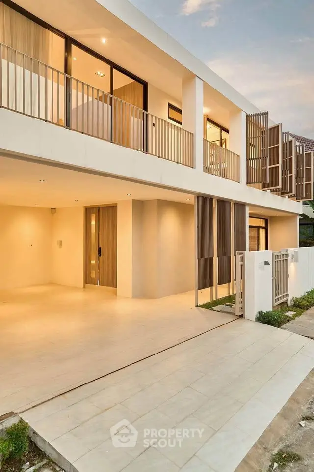 Modern two-story house with spacious balcony and sleek design, perfect for contemporary living.
