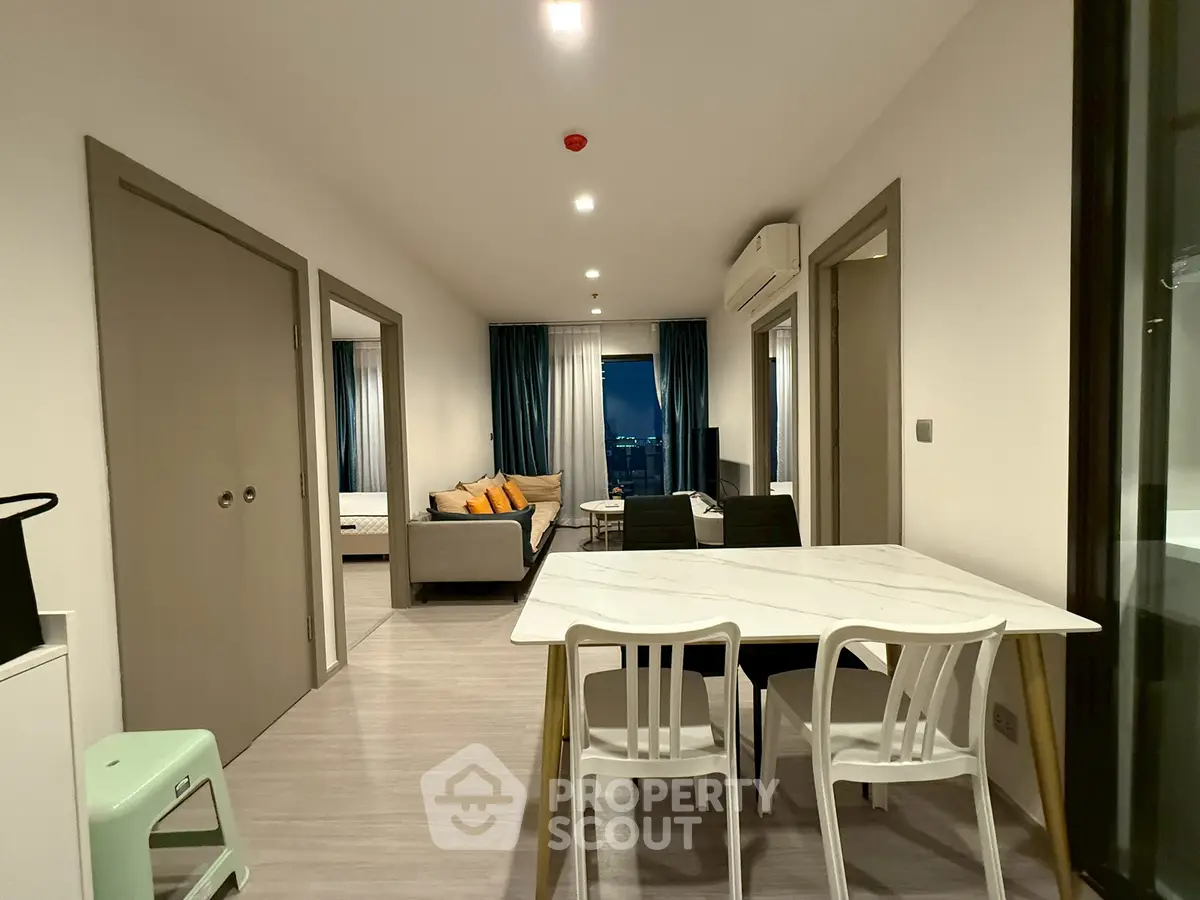 Modern apartment interior with open layout, dining area, and cozy living space.