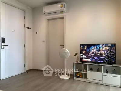 Modern living room with air conditioning and stylish TV setup, perfect for cozy evenings.