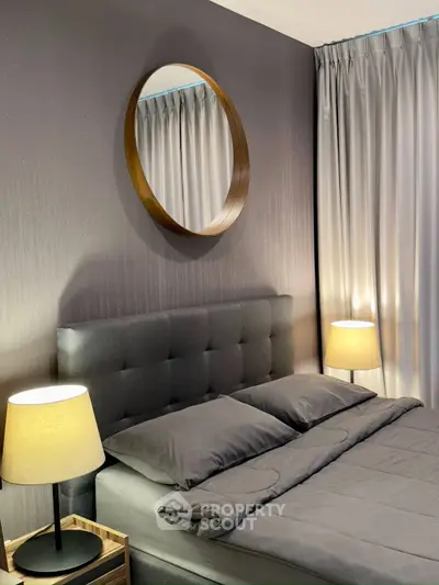 Elegant bedroom with modern decor, featuring a stylish mirror and cozy lighting, perfect for relaxation.
