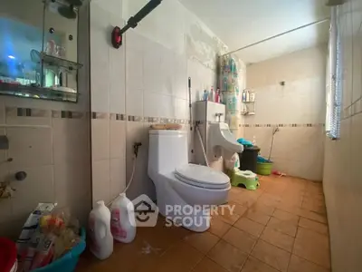 Spacious bathroom with modern fixtures and ample storage, ideal for family use.