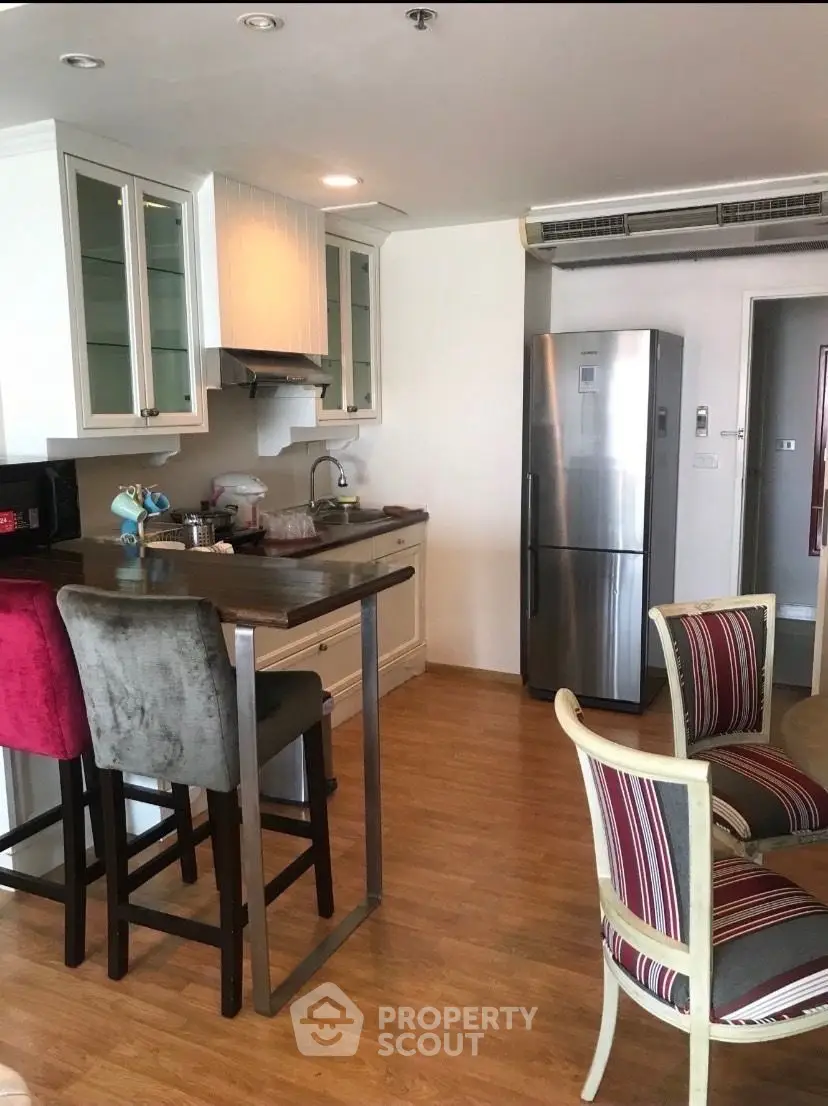 Charming kitchen with modern appliances and cozy dining area, perfect for intimate gatherings.