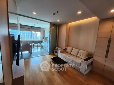 Modern living room with wooden flooring and cozy sofa in open layout apartment