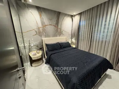 Luxurious bedroom with elegant marble accent wall and modern decor