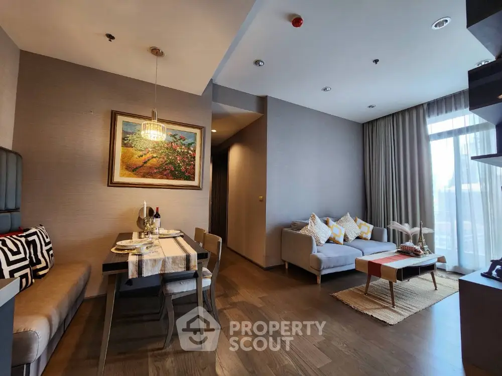 Modern living room with dining area, stylish decor, and natural light