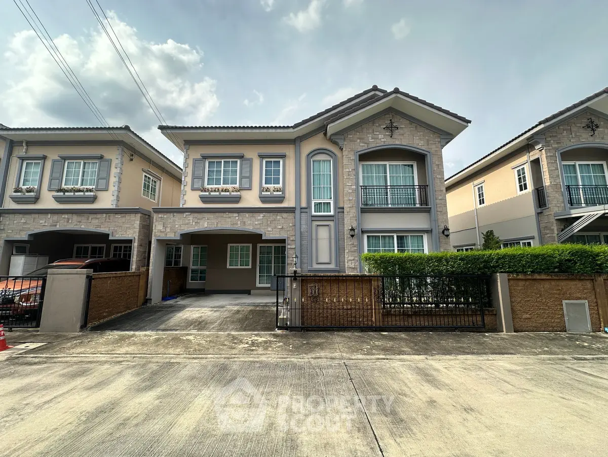 Charming two-story suburban house with modern facade and spacious driveway, perfect for family living.