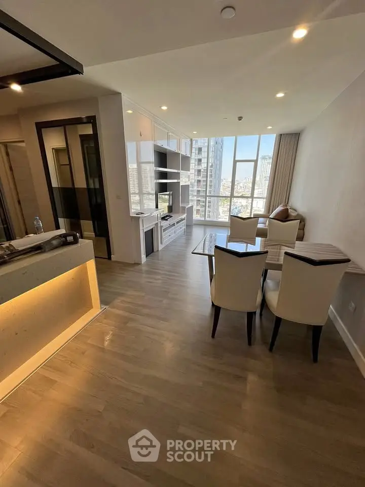 Spacious modern living room with city view, elegant furniture, and natural light.