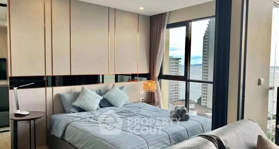 Luxurious bedroom with ocean view in modern high-rise apartment