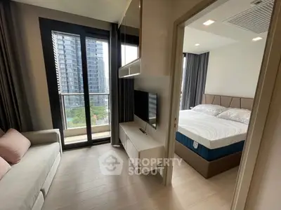 Modern apartment with cozy living room and bedroom, featuring large windows and a balcony view.