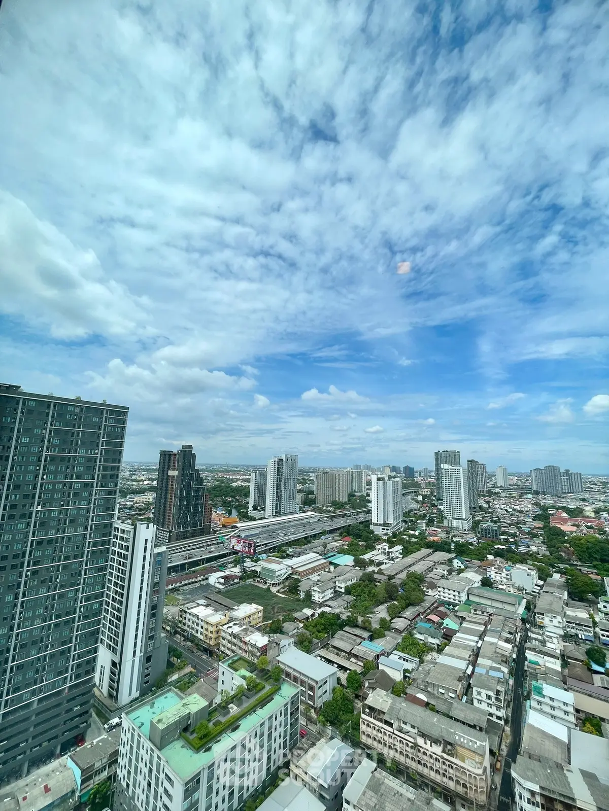 Stunning cityscape view from high-rise building showcasing urban skyline and vibrant city life.